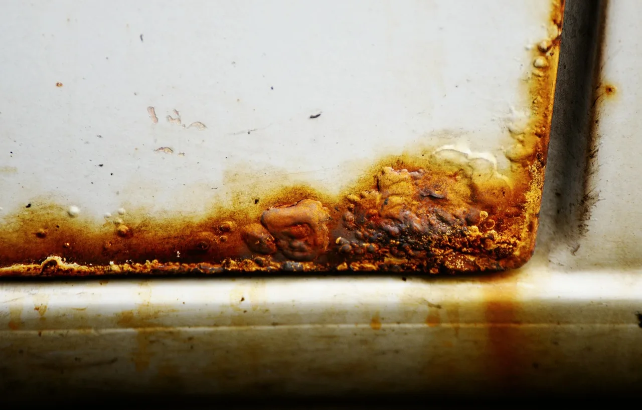 rust, automobile, car door, rusted, damage, auto repair shop, decay, broken. Rocker panel protection vinyl wrap vs PPF